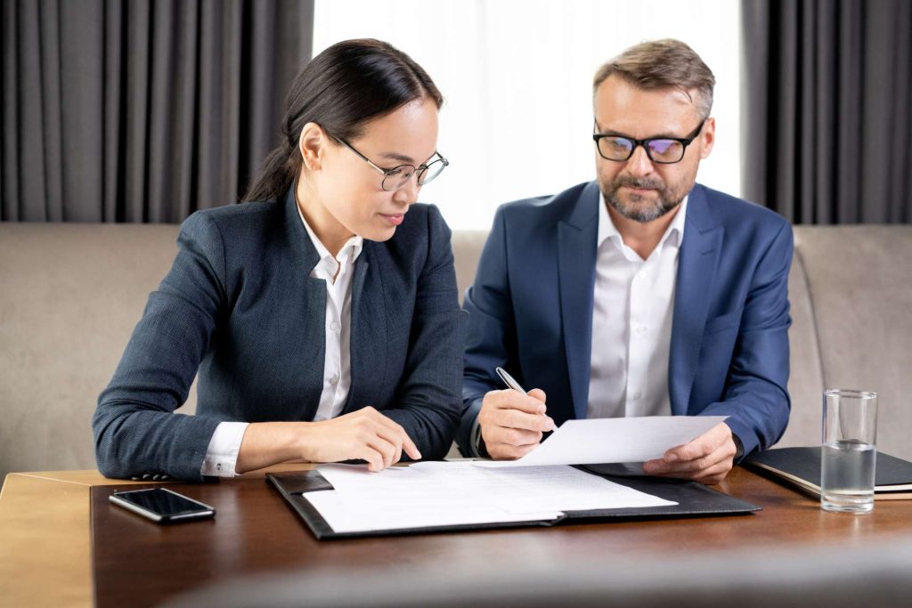 Buyer and real estate attorney reviewing title records and property ownership issues