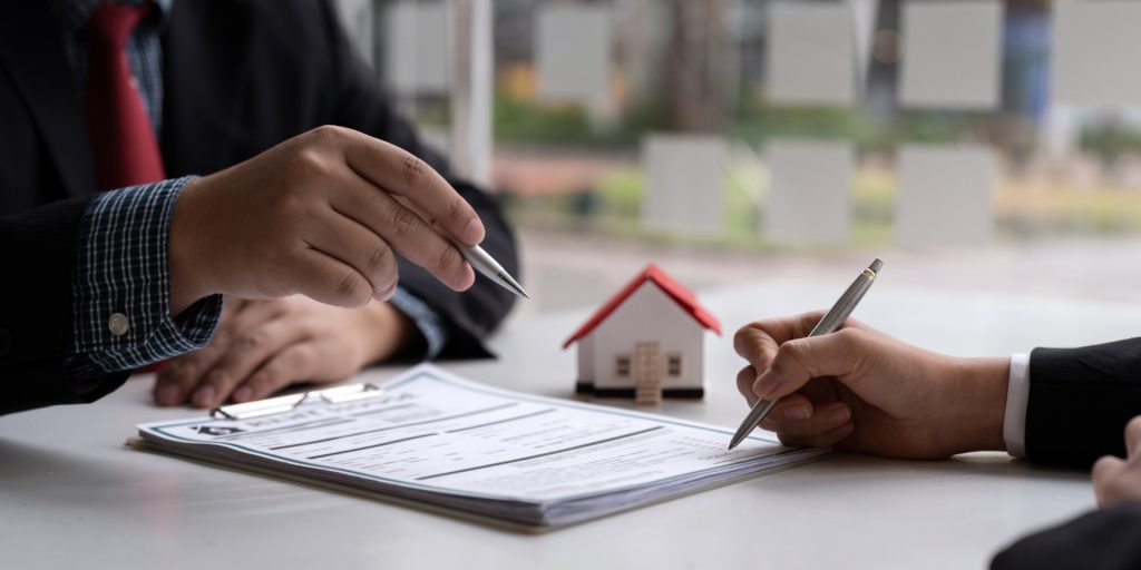 Real estate professional reviewing deed documents for ownership and recording errors