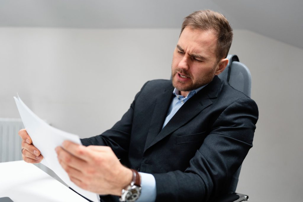 Real estate attorney reviewing a deed for legal description, ownership, and recording errors