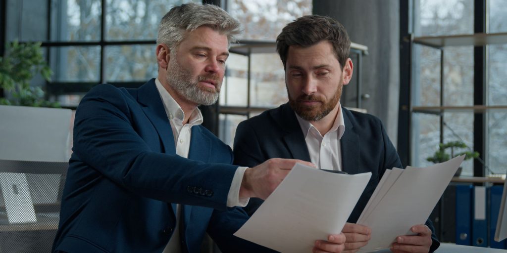 Real estate attorney reviewing purchase agreement and earnest money documents with a buyer