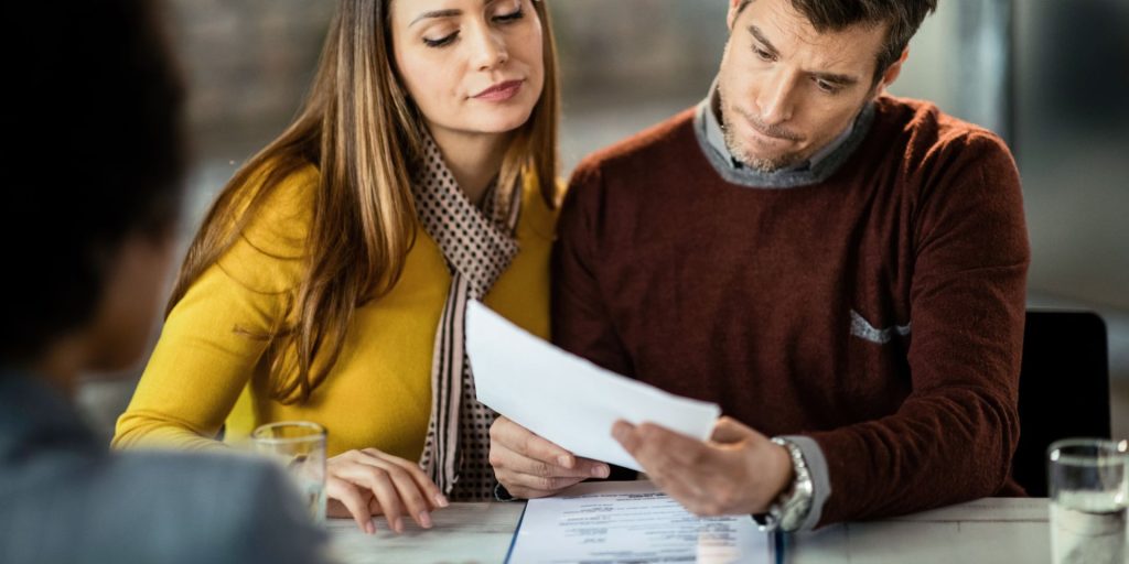 Property buyer reviewing owner's and lender's title insurance documents