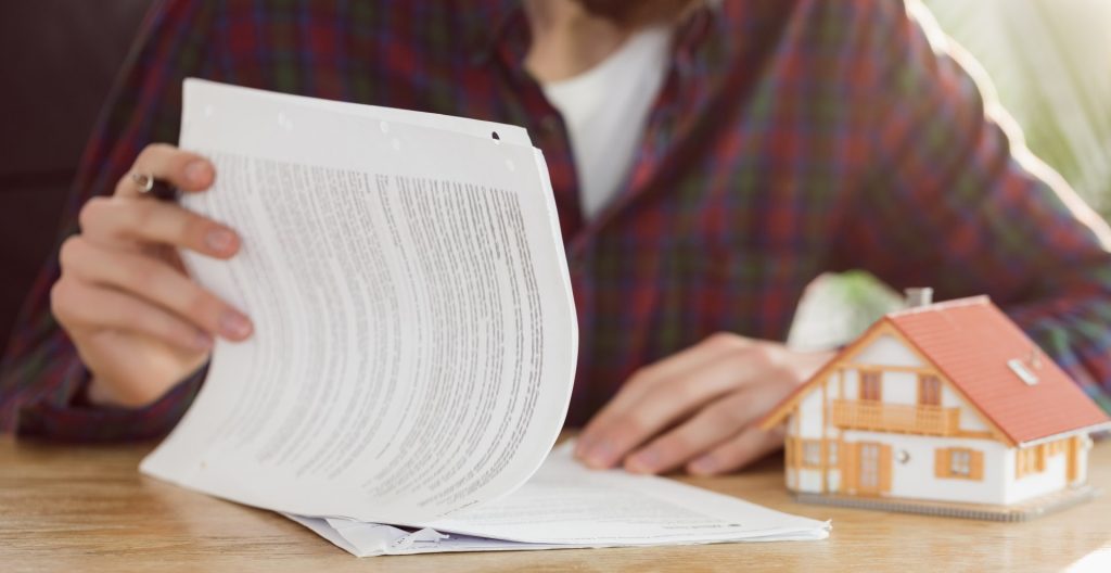 Property deed being reviewed to document the transfer of real estate ownership