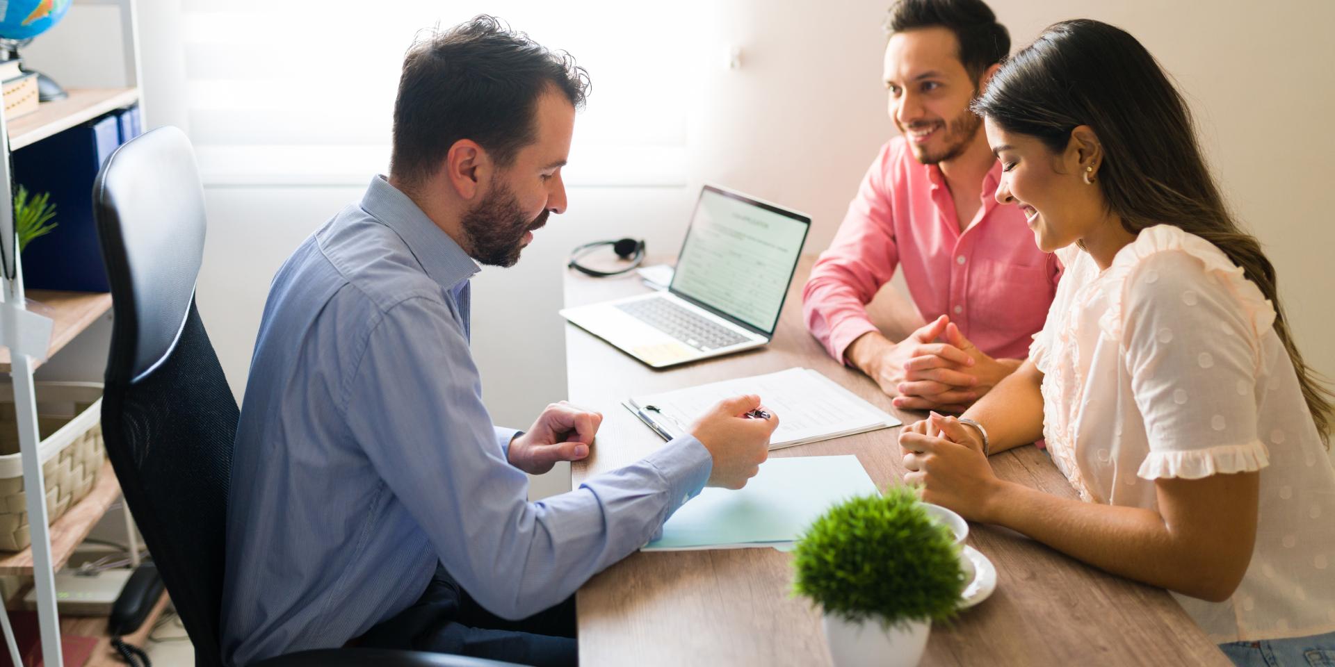 Real estate attorney reviewing title documents with a property buyer before closing