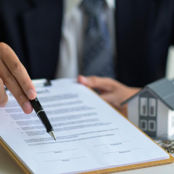 sell-home-without-realtor-san-diego-lawyer Homeowner reviewing FSBO property sale documents with San Diego real estate attorney in California