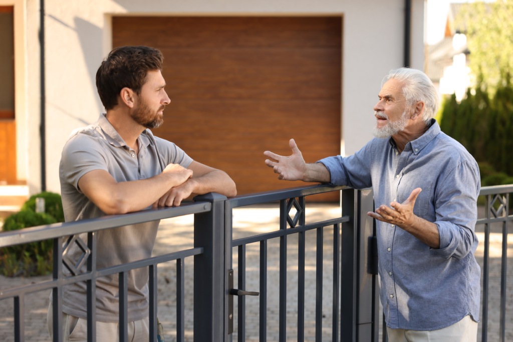 neighboring homeowners discussing a fence and property boundary dispute in Las Vegas