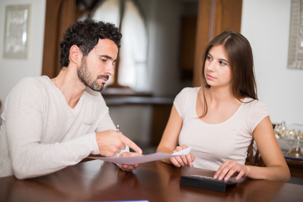 Nevada homeowners reviewing documents concerning a house buyout after a relationship breakup
