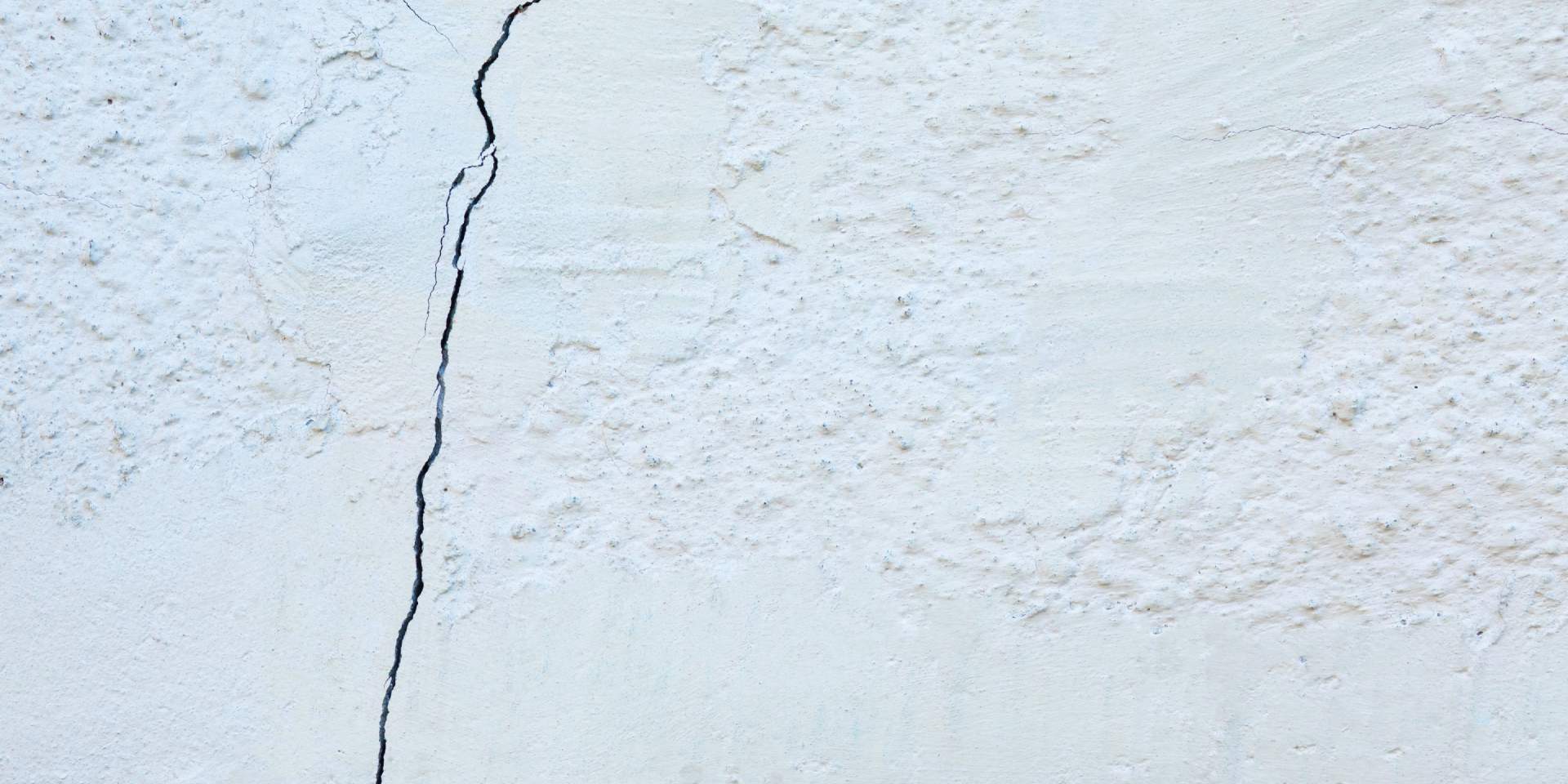 Stucco cracks appearing on the exterior wall of a new home in Las Vegas