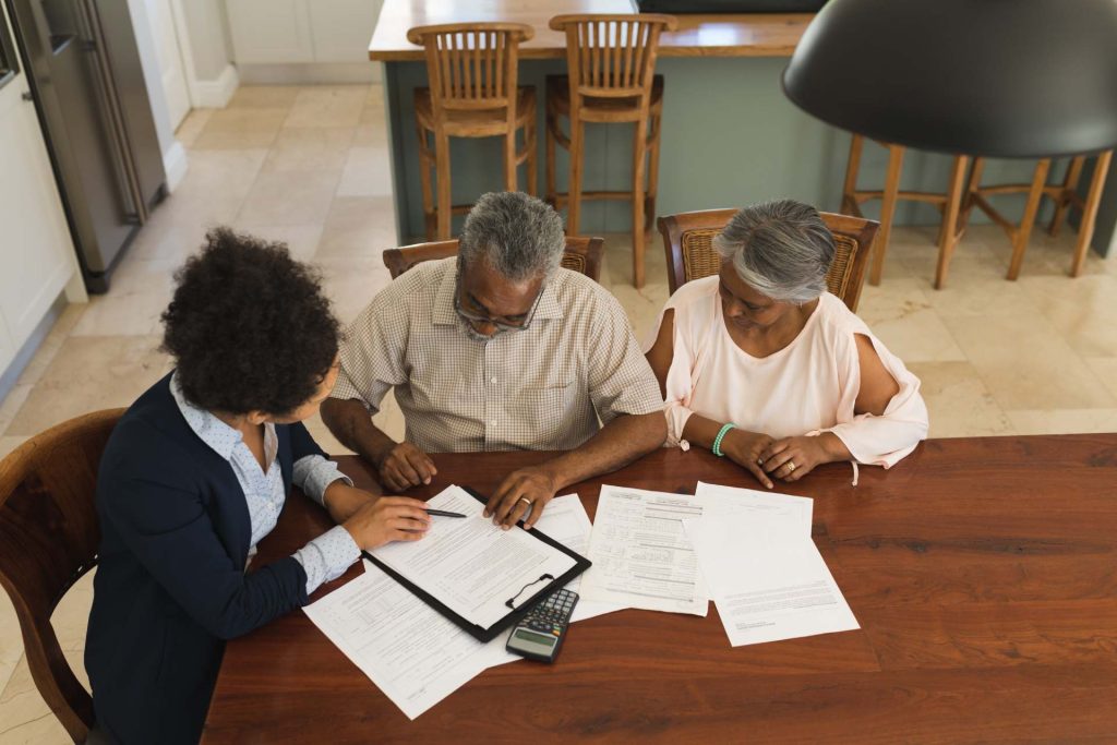 Las Vegas homeowner reviewing foreclosure defense documents with an attorney