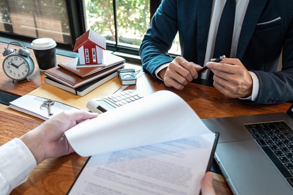 Buyer meeting with a real estate lawyer at a Nevada closing table to review loan and deed documents
real estate lawyer
