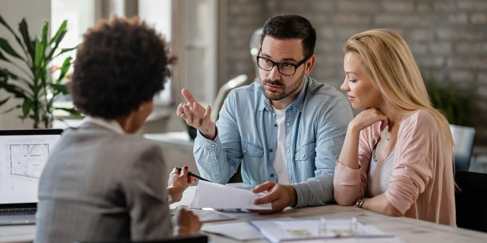 property-partner-dispute-real-estate-lawyer real estate lawyer reviewing a property deed with an owner whose property partner stopped cooperating, real estate lawyer