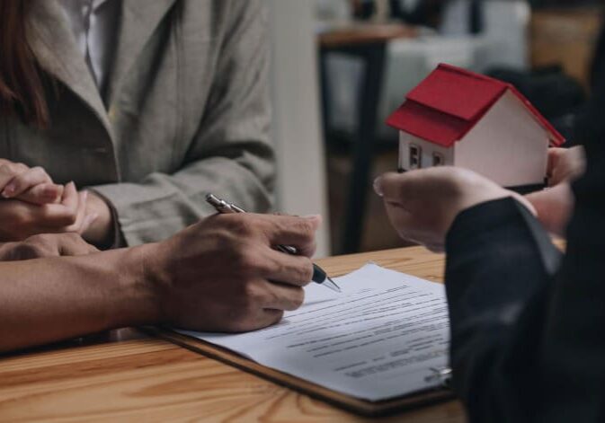 real estate lawyer reviewing purchase documents with a client after a bad property deal, real estate lawyer