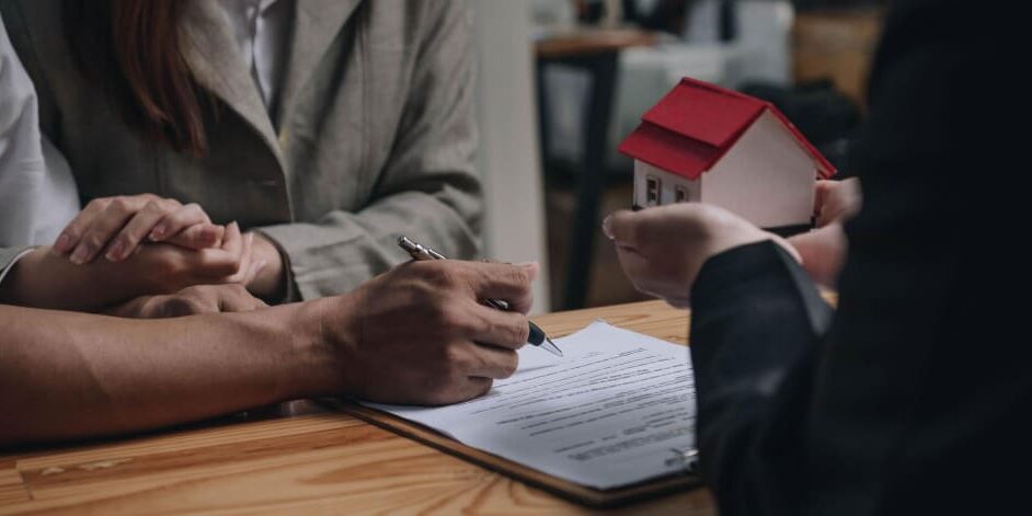 real-estate-lawyer-recover-money-bad-property-deal real estate lawyer reviewing purchase documents with a client after a bad property deal, real estate lawyer