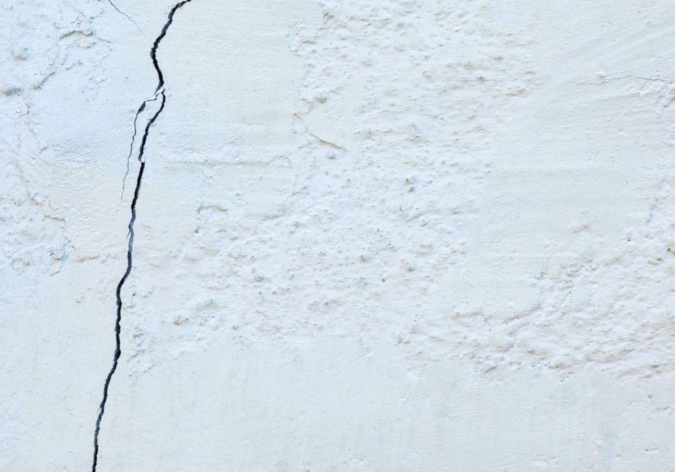 Stucco cracks appearing on the exterior wall of a new home in Las Vegas